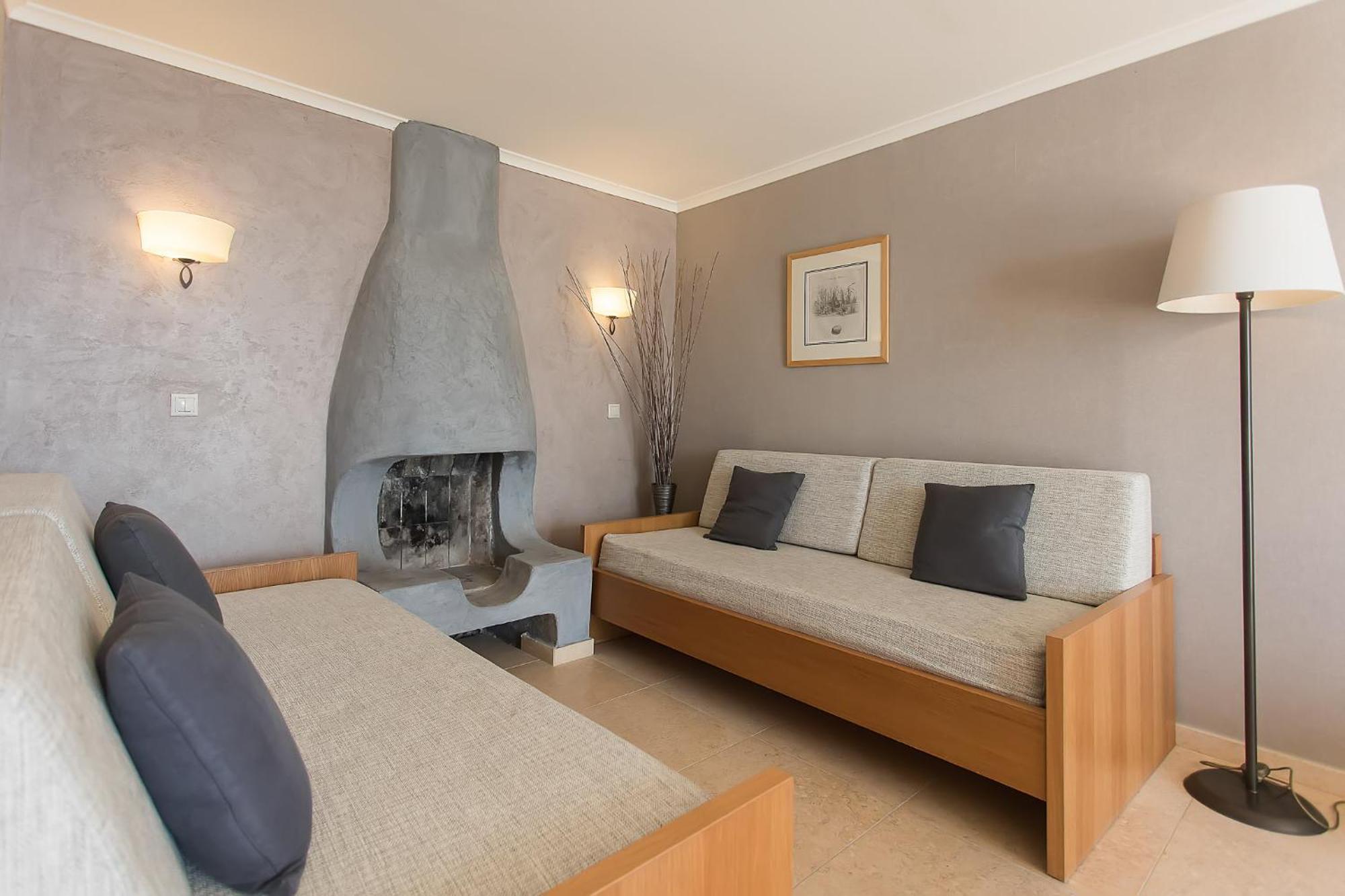 Corfu Holiday Palace Perama  Bagian luar foto A living room with a fireplace